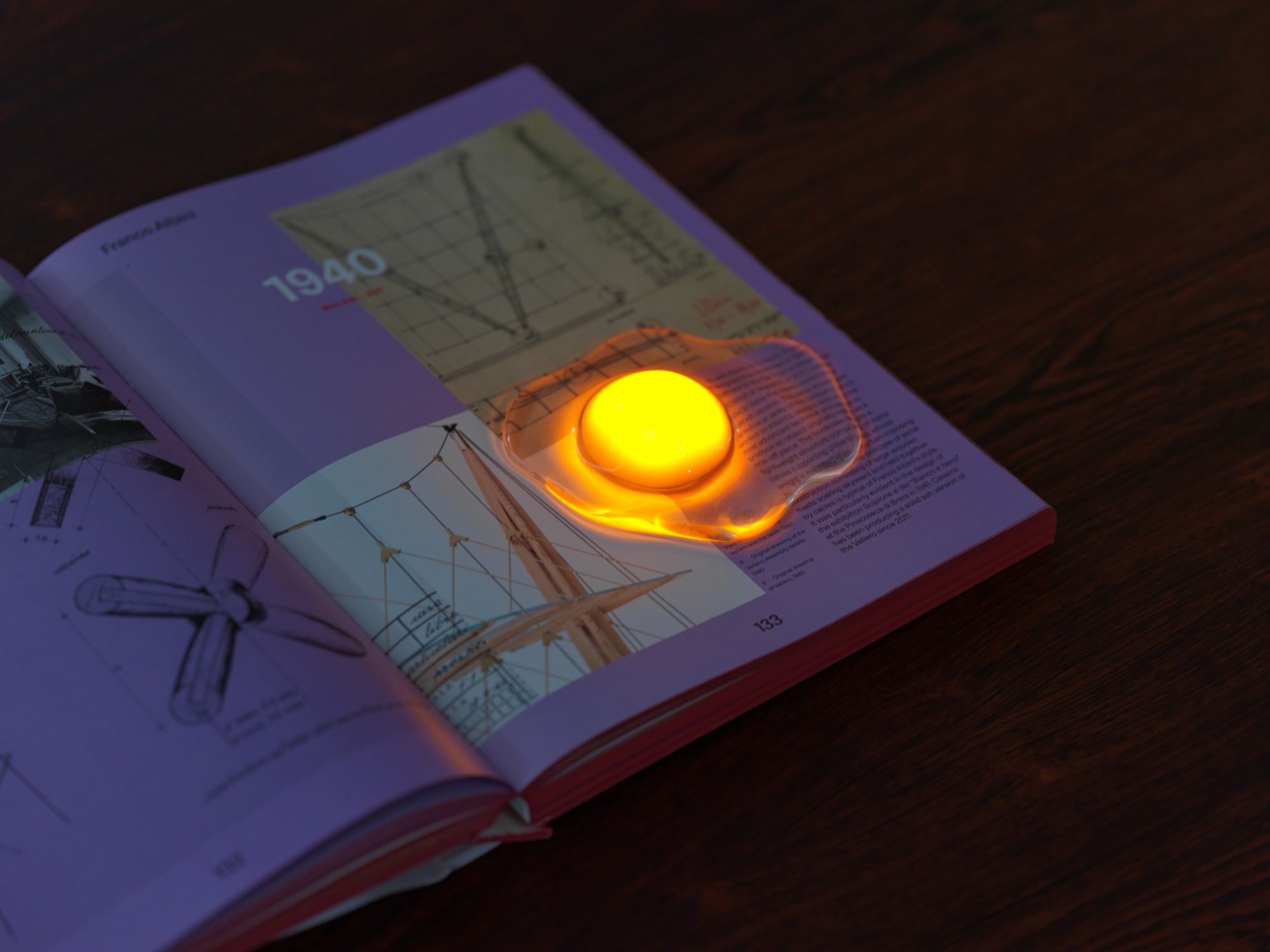 EL27 egg light glowing on an open book